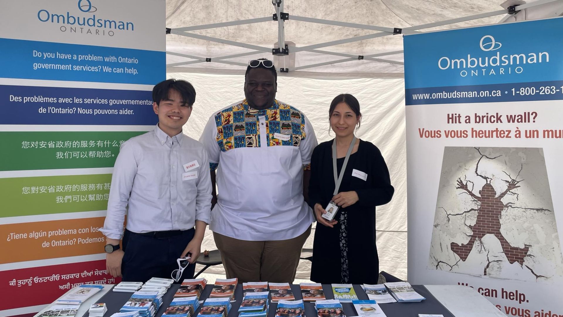 Group of people standing behind a table of informational materials