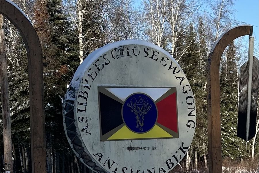 Asubpeeschoseewagong Netum Anishinabek Sign depicting a medicine wheel and "Asubpeeschoseewagong Netum Anishinabek" written around it.