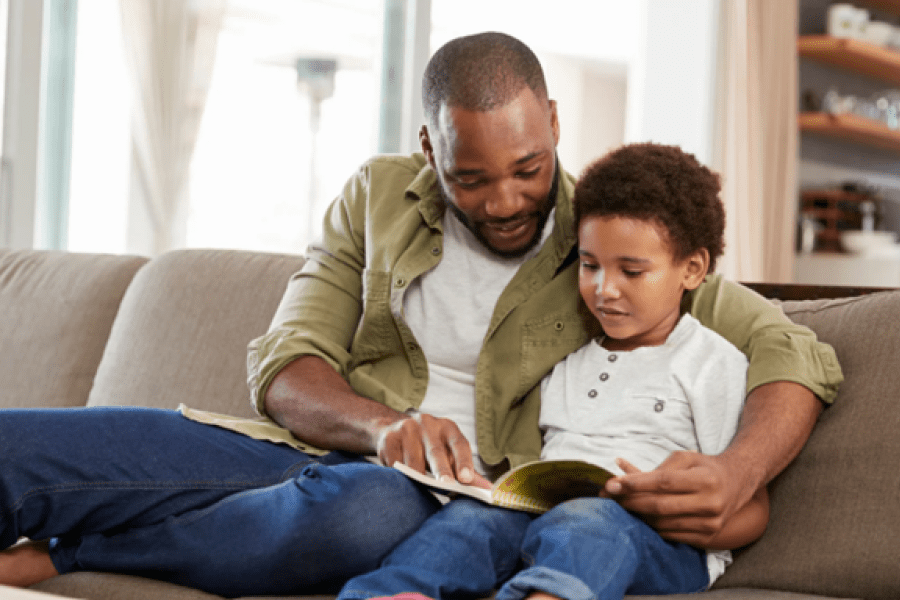Father and son reading a book together