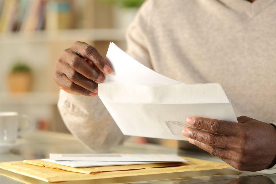 Hands opening a letter