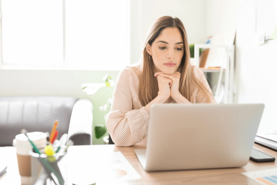 Woman at desk looking at computer