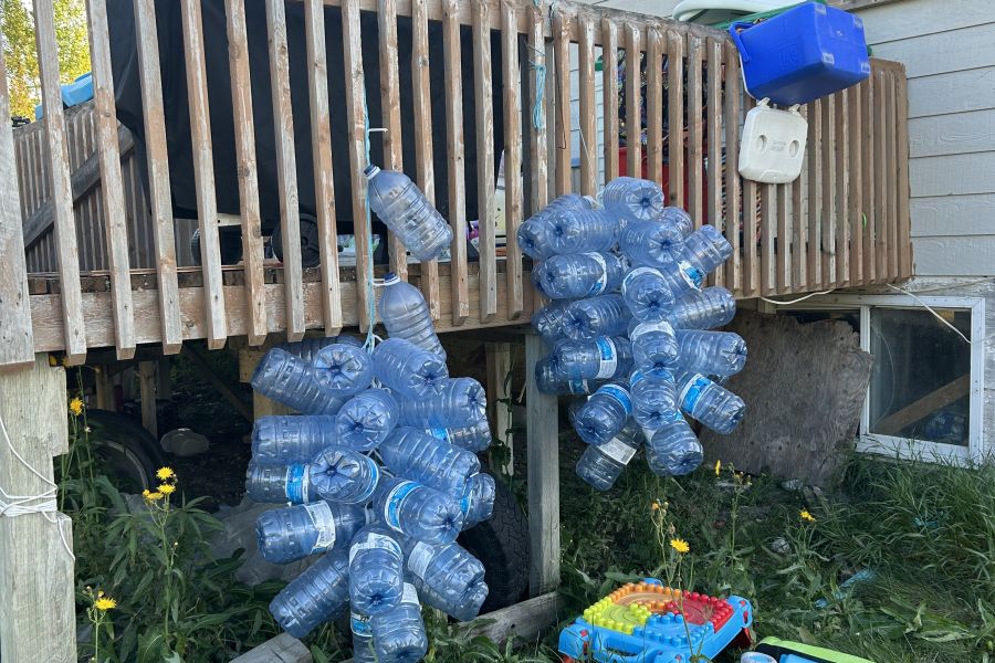 Empty plastic bottles hang from a patio in Neskantaga First Nation